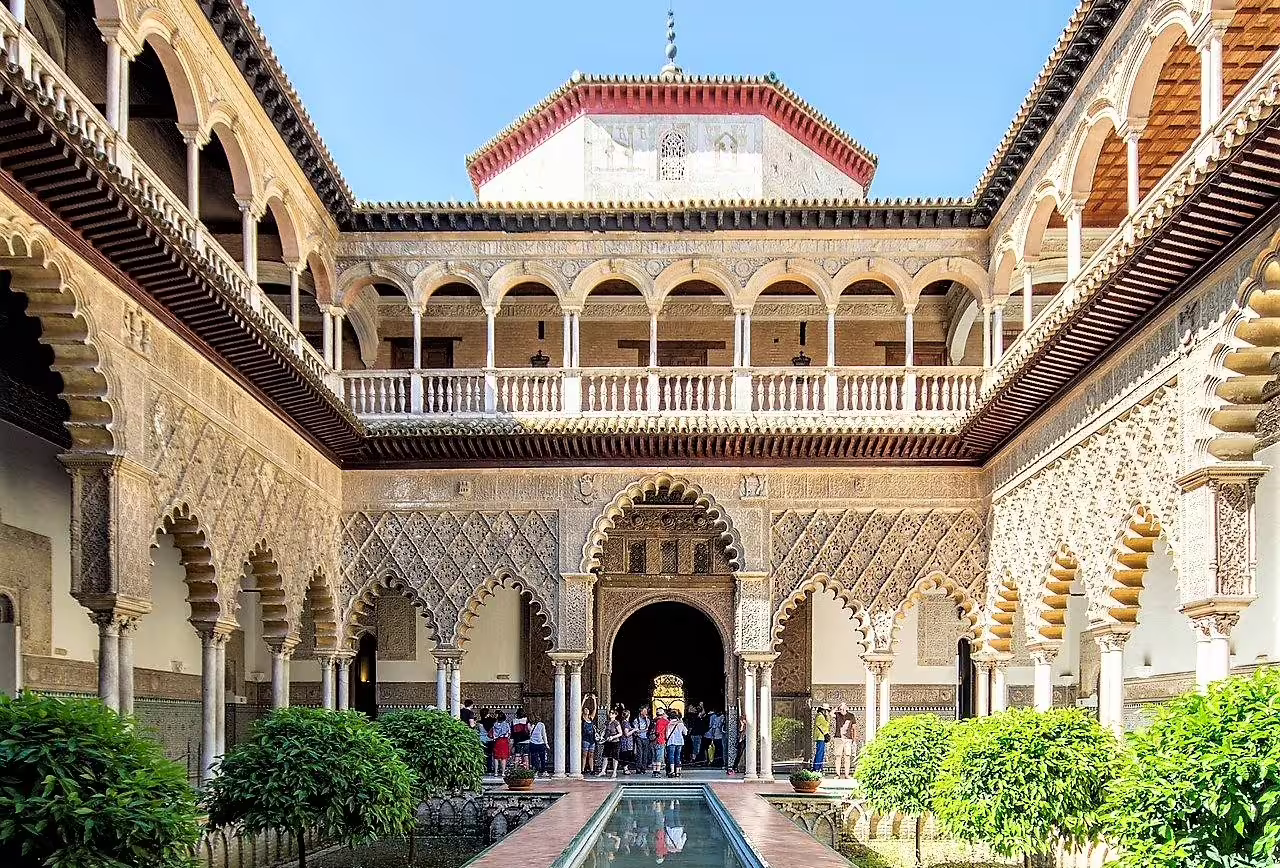 Real Alcázar of Seville courtyard with arches and reflecting pool, highlight stop on a private walking tour