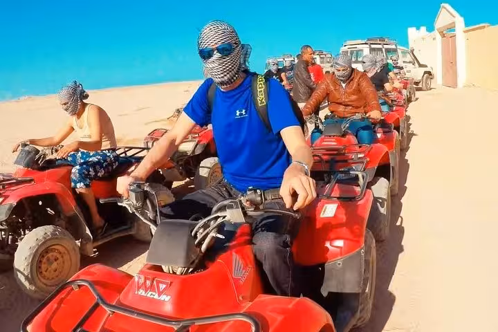Group of tourists lined up on red ATVs for Hurghada desert safari, 5-hour tour to El Gouna and Safaga