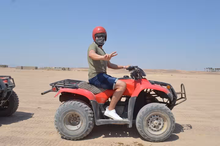 Rider on red ATV quad bike in Sharm El Sheikh desert, ideal for sunrise or sunset quad safari tour