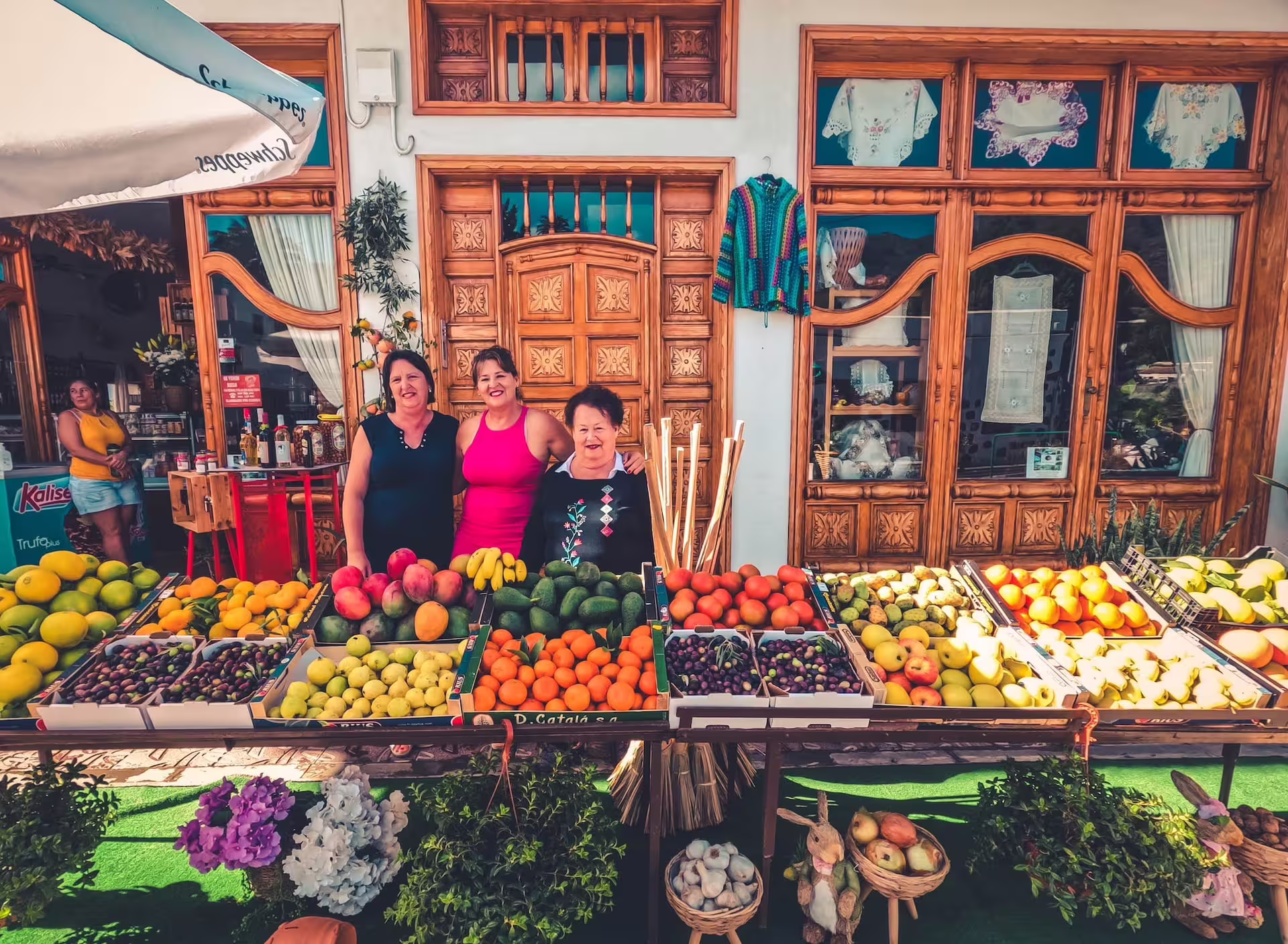 Local market stall featuring colorful fruits and friendly vendors on the Red Canyon Tour's authentic tasting adventure.