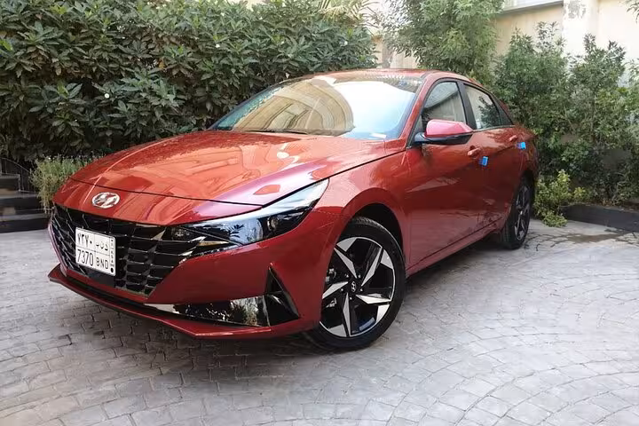 Red private car for Marsa Alam to Hurghada Airport transfer, reliable door-to-door service with AC