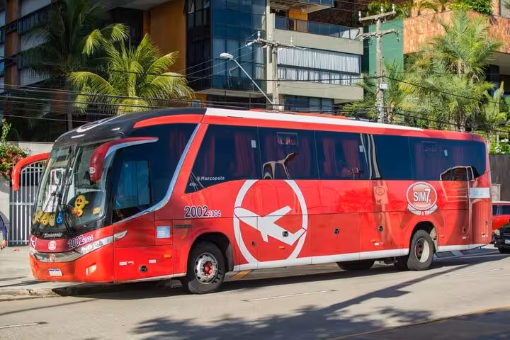 Modern red coach for Beach Park transfer in Fortaleza, comfortable seats, air conditioning and luggage space