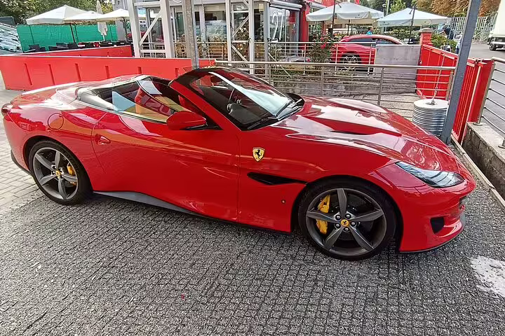 Red Ferrari convertible parked in Modena, featured on a private Ferrari Museum tour with balsamic vinegar experience