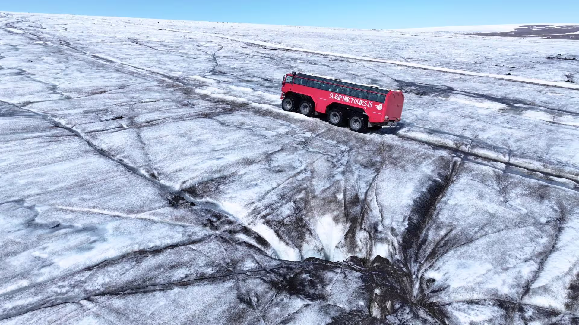 Red Glacier Monster Truck driving on Langjökull glacier near Gullfoss, Iceland super truck adventure tour