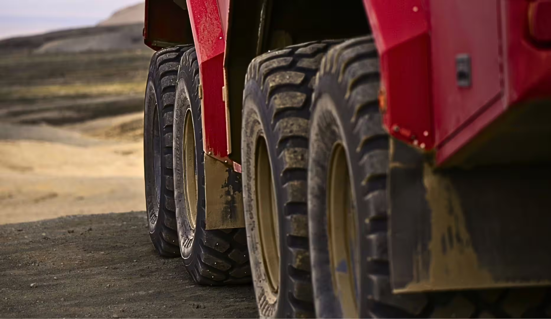 Close-up of red monster truck tires on rough track, Langjökull glacier tour from Gullfoss in Iceland