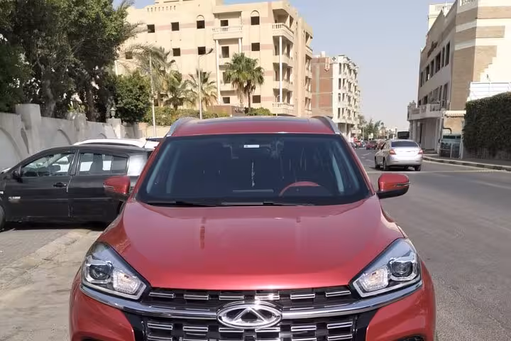 Red AC private transfer car in Hurghada, comfortable airport to hotel pickup with professional driver