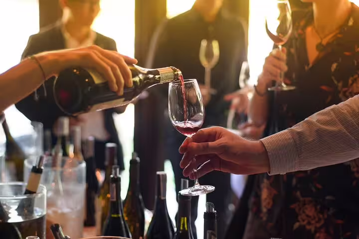 Sommelier pouring red wine into a glass at a Chateauneuf du Pape wine tasting event
