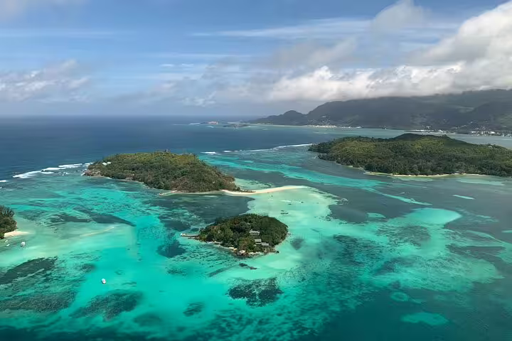 Aerial view of turquoise waters and lush islands, ideal for a private snorkeling and fish feeding day trip.
