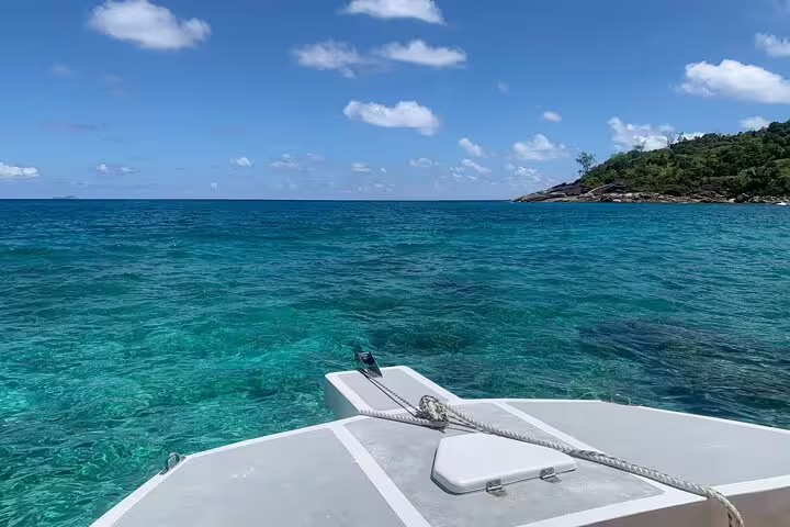 Experience vibrant turquoise waters and lush island views on a Reef Safari snorkeling adventure.