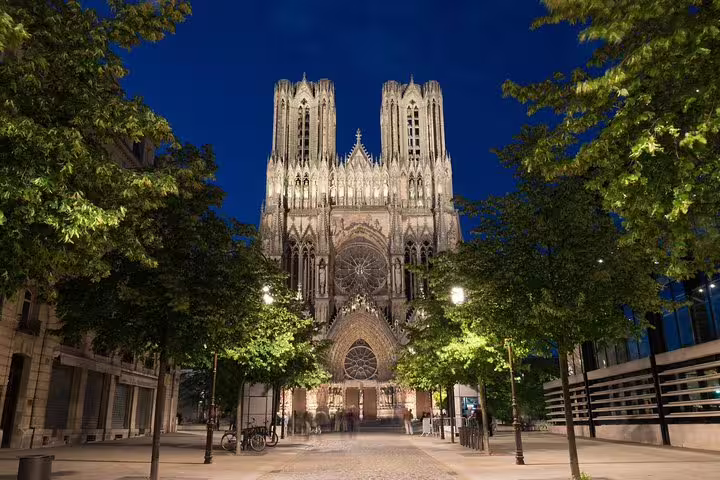 Reims Cathedral illuminated at night, a highlight on Champagne and Reims tasting day trip from Paris