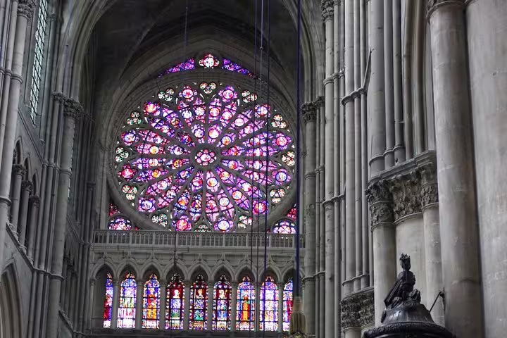 Stained-glass rose window inside Reims Cathedral, a highlight on Champagne and Reims tasting day trip from Paris