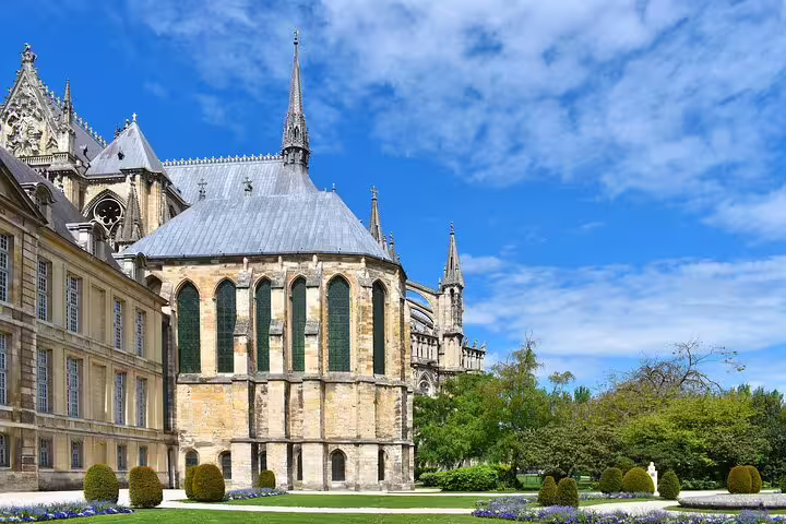 Reims Cathedral exterior and gardens on a sunny day, landmark stop on the Reims self-guided e-scavenger hunt