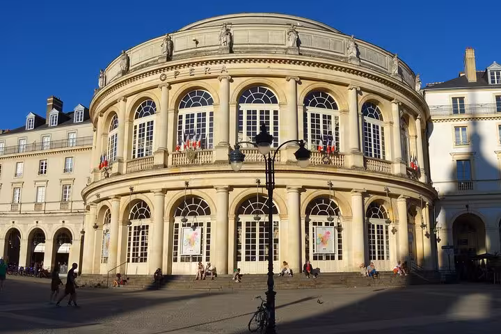 Historic Rennes Opera House illuminated in sunlight, showcasing its grand architecture during a city centre walking tour.