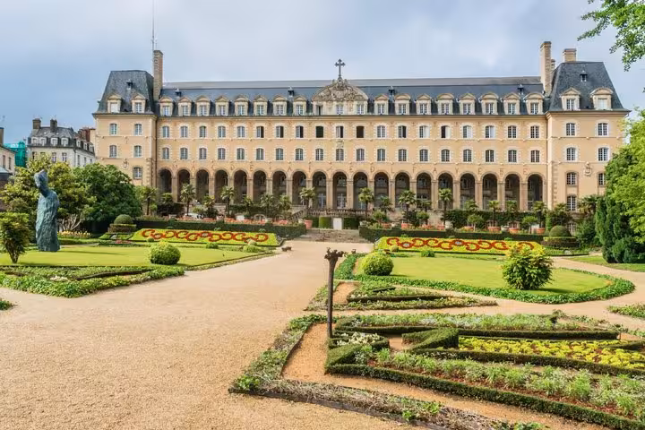Palais Saint-Georges formal gardens with manicured hedges and flower beds in Rennes, France