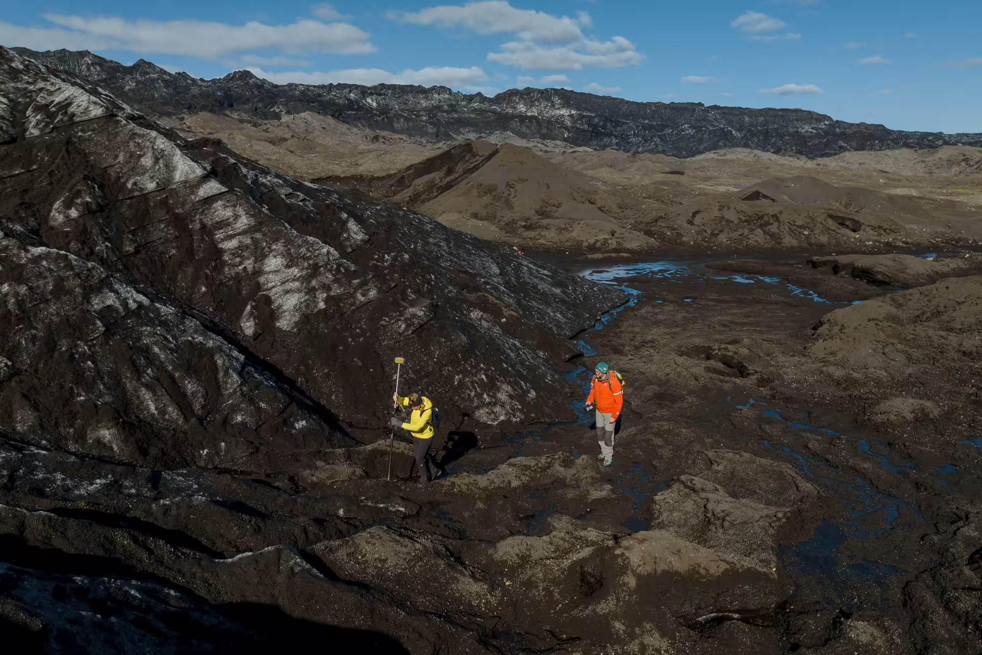 Two researchers mapping ice on Katla glacier during a guided glacier research tour in Iceland