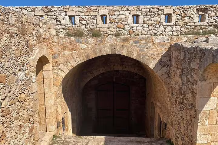 Historic stone archway entrance at Rethymno, part of the private tour experience from Chania, highlighting ancient architecture.