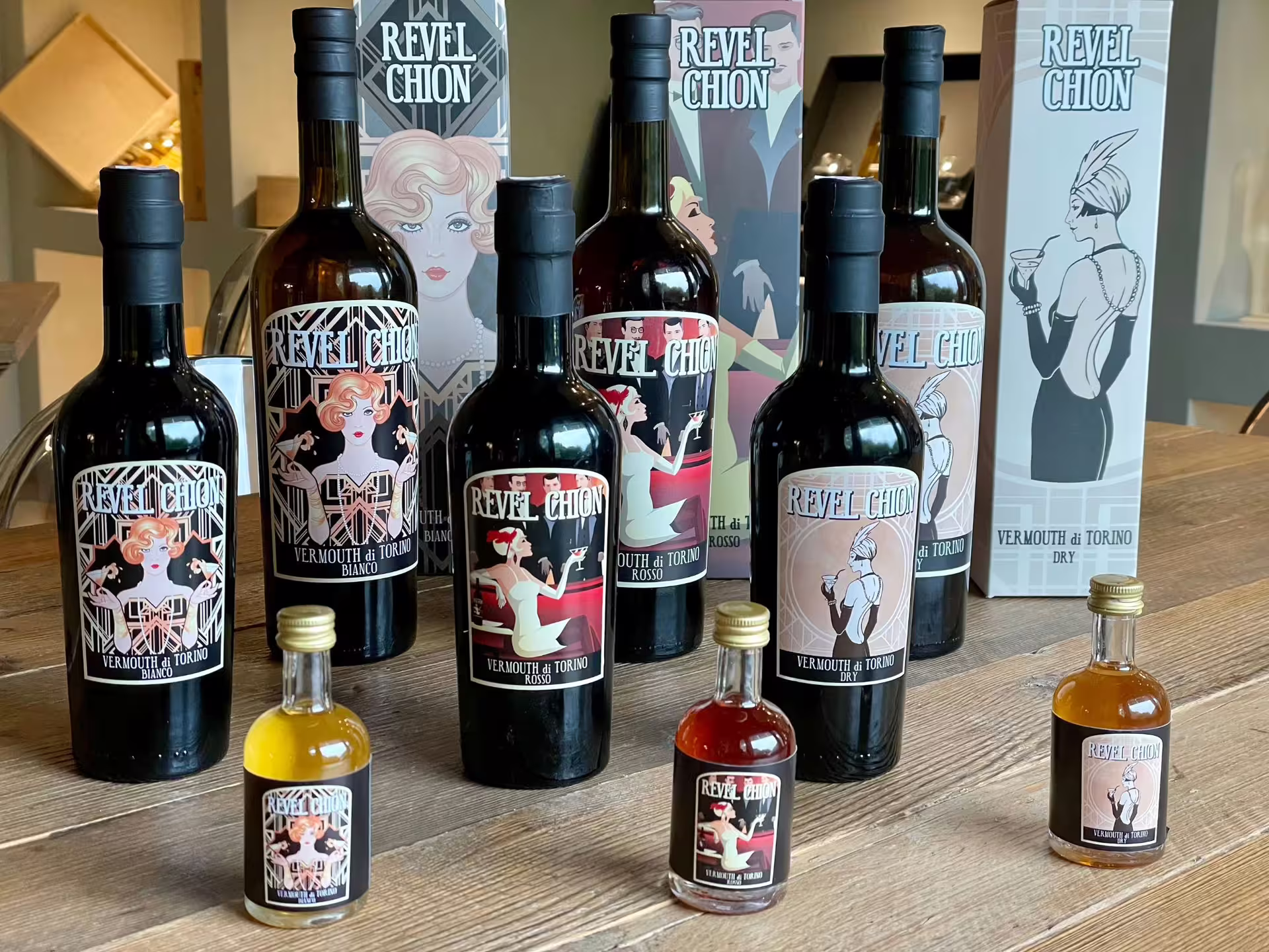 Variety of Revel Chion vermouth bottles showcased at a Turin distillery tour and tasting event.