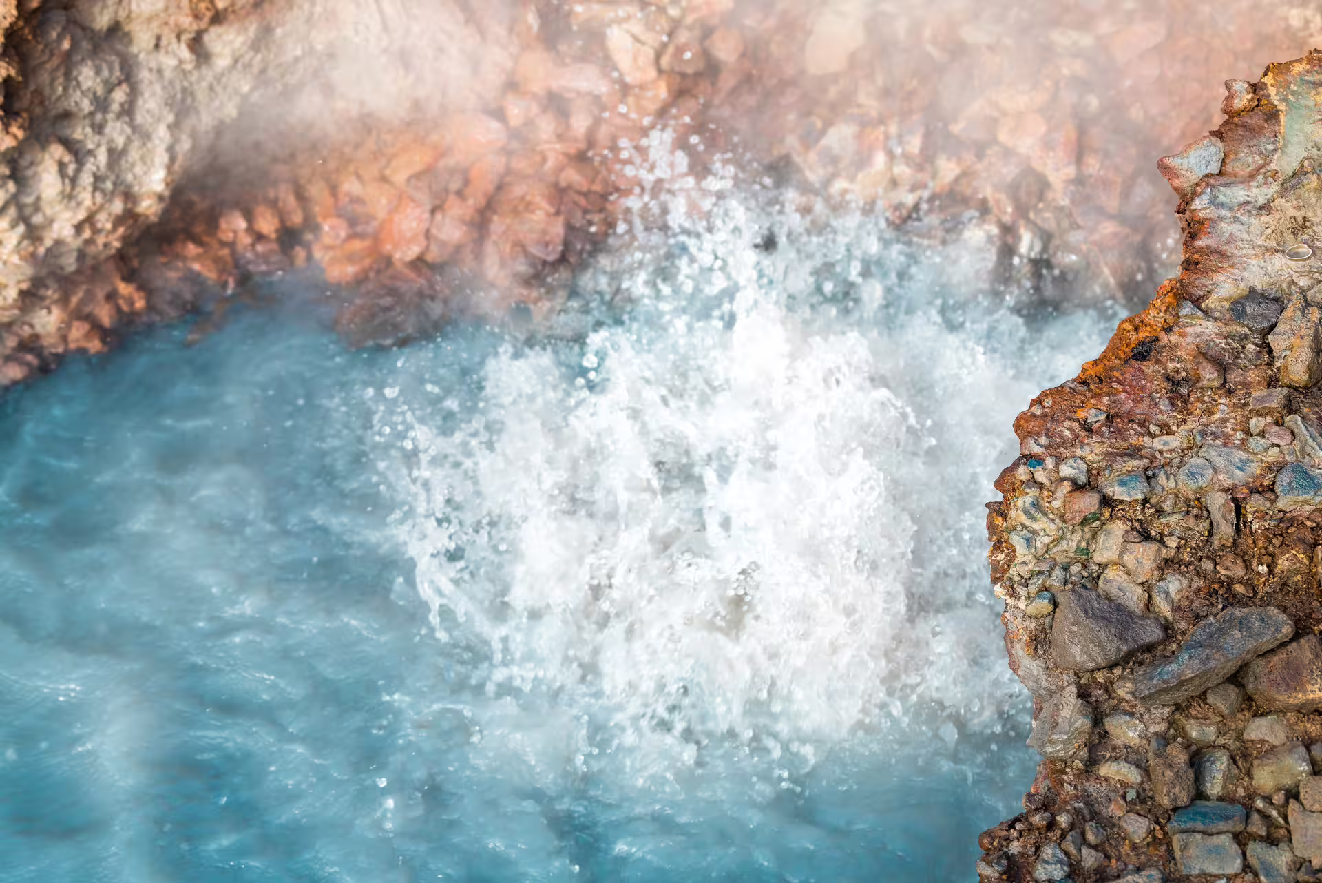 Steaming geothermal hot spring pool bubbling in Reykjadalur valley, highlight of private hot river hike in Iceland