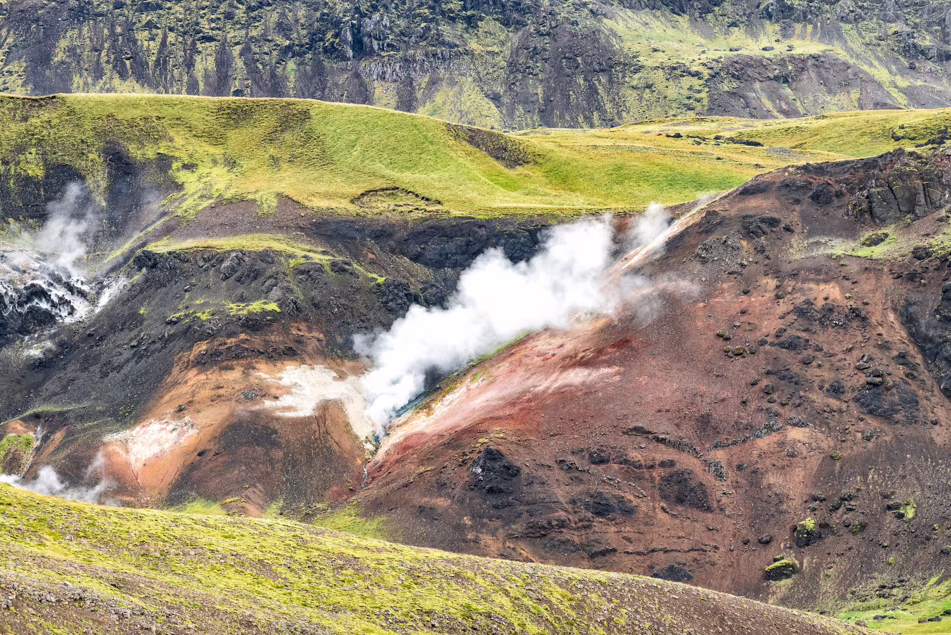 Steaming geothermal vents in Reykjadalur Valley on a private hot river hike near Hveragerdi, Iceland