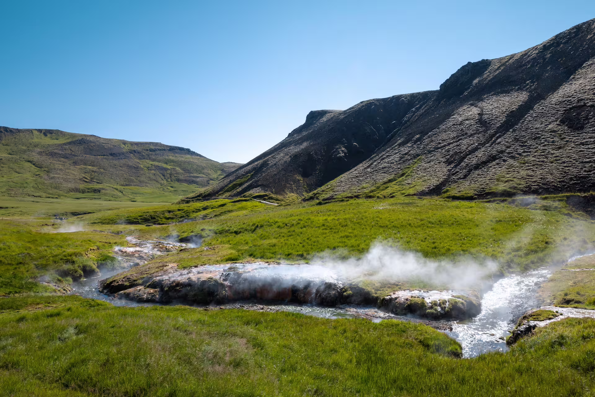Hot river steam rising in Reykjadalur Valley, Iceland, on a private guided hike to geothermal bathing pools