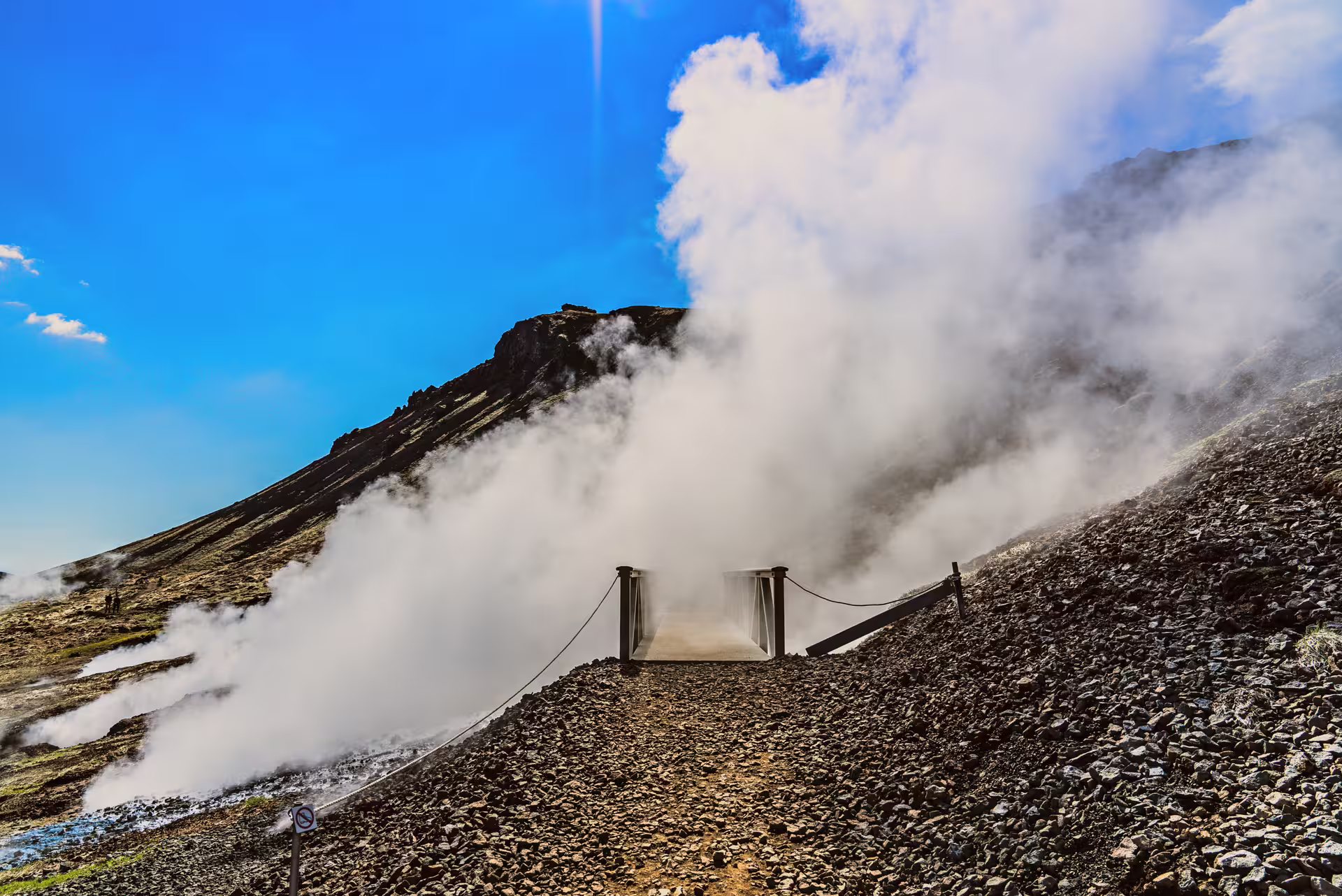 Steaming geothermal trail bridge on the private Reykjadalur Hot River Hike near Hveragerdi, Iceland