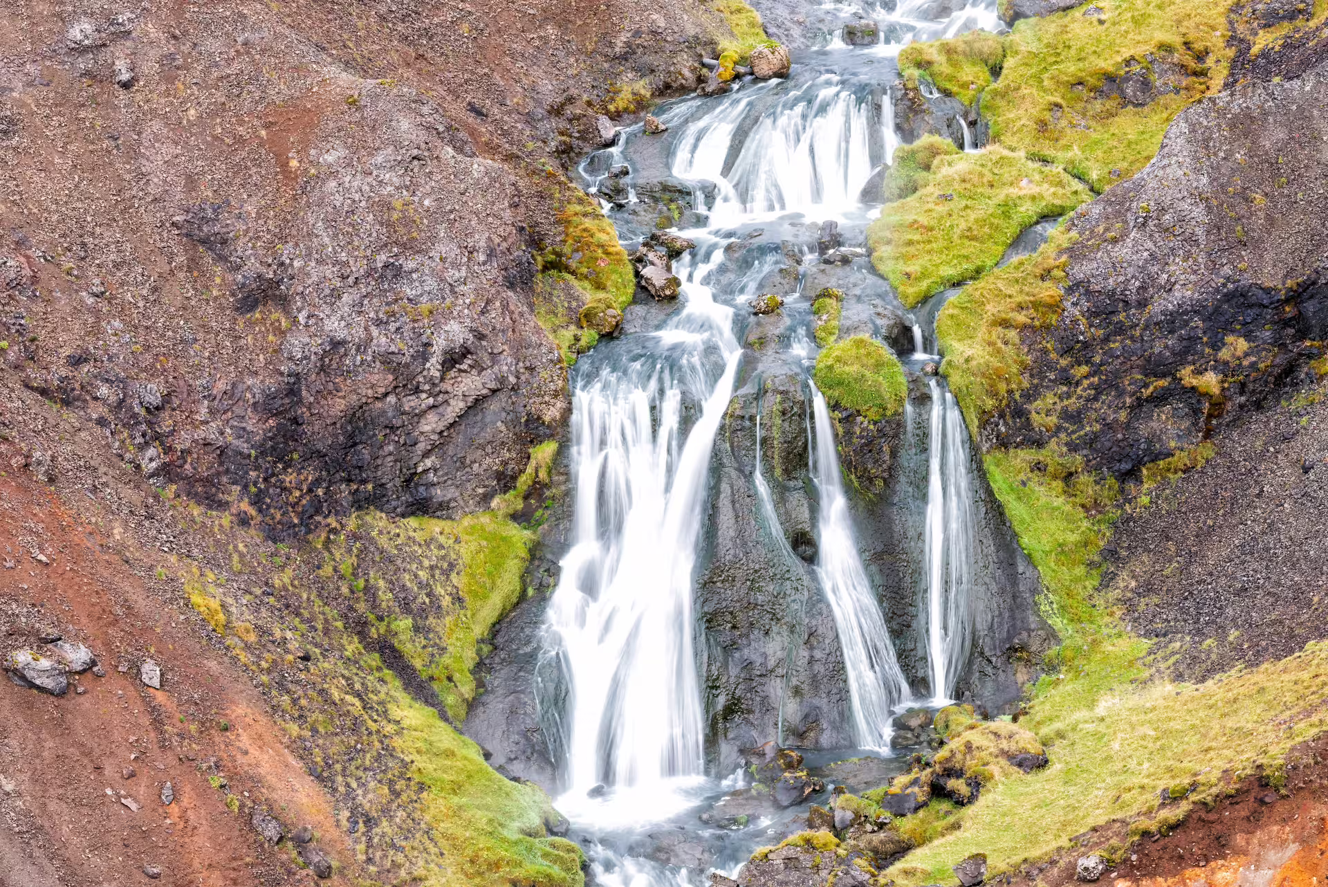 Waterfall on the Reykjadalur trail, a scenic stop on the private hot river hike from Hveragerdi, Iceland