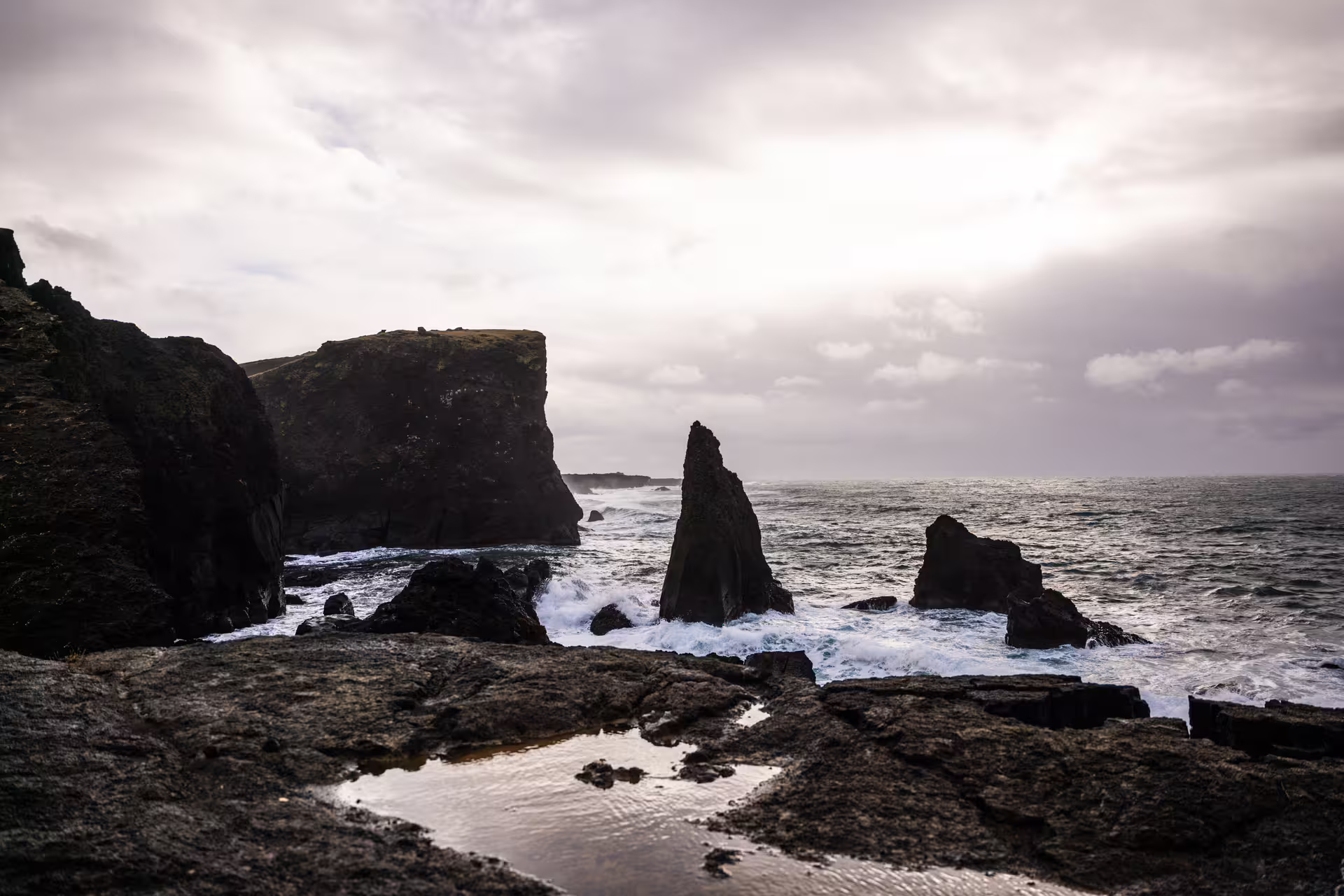 Dramatic black lava rock sea stacks with crashing Atlantic waves on a Reykjanes Peninsula Iceland photography tour