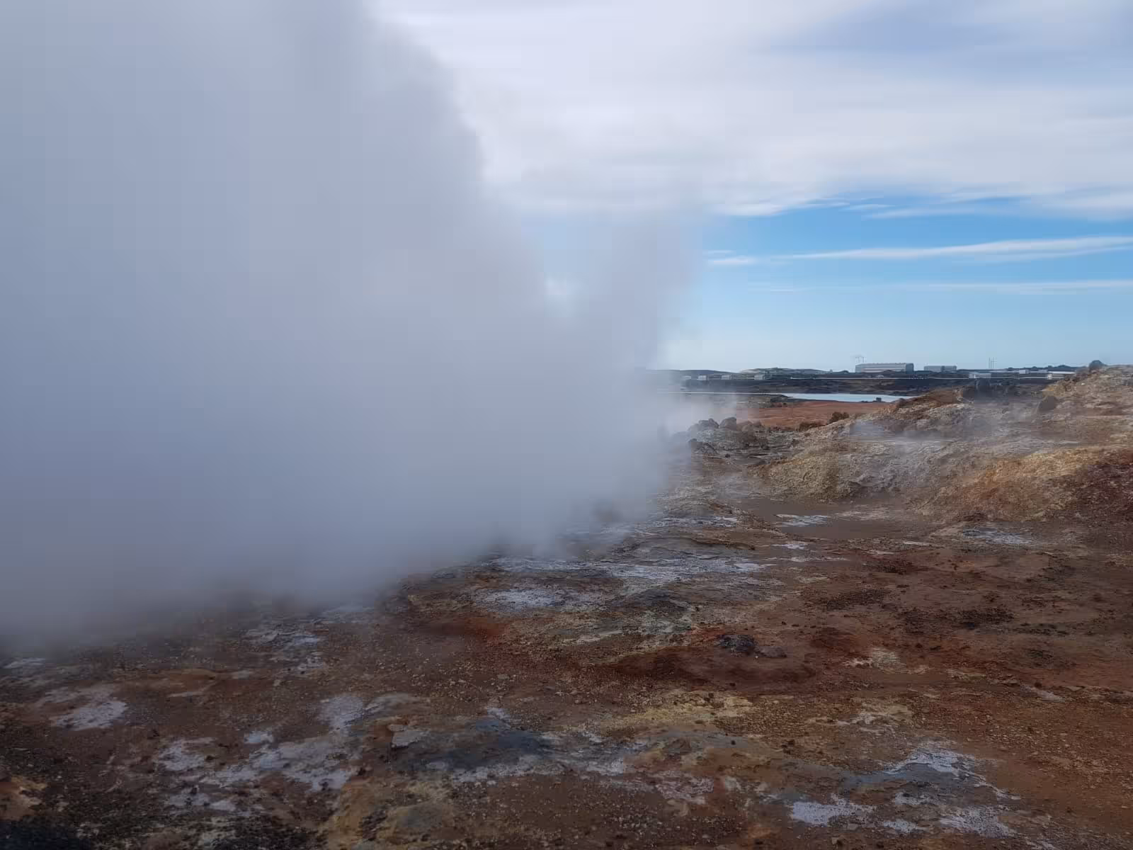 Geothermal steam venting from colorful sulfuric ground at Reykjanes Geopark, Iceland