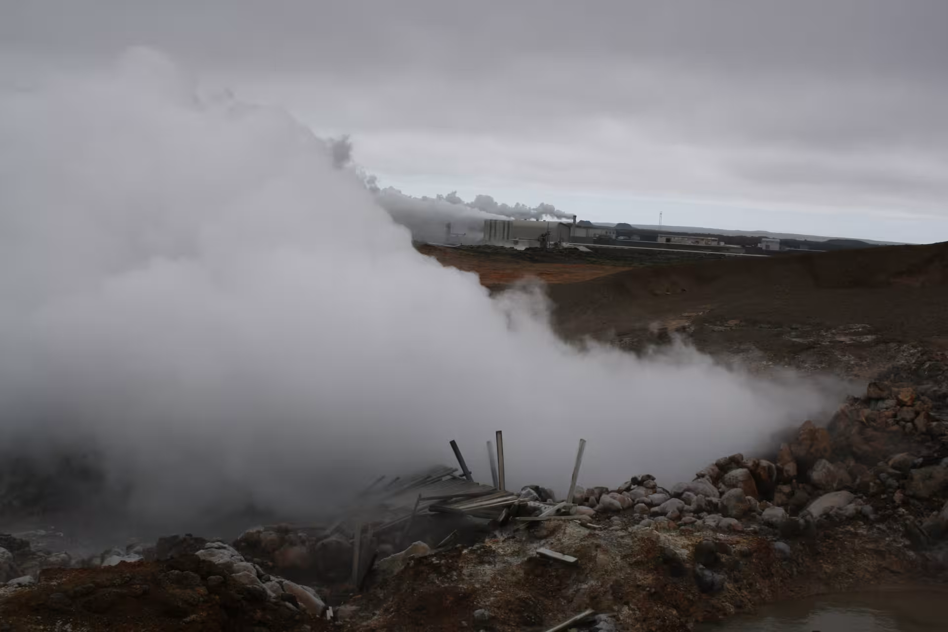 Steaming geothermal field on Reykjanes Wonders tour near Reykjavik, volcanic terrain and power plant views