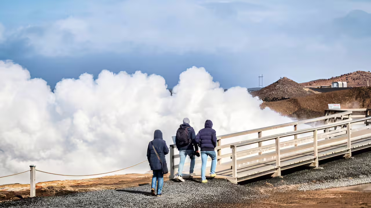 Tourists watching geothermal steam vents on Reykjanes Peninsula, Iceland