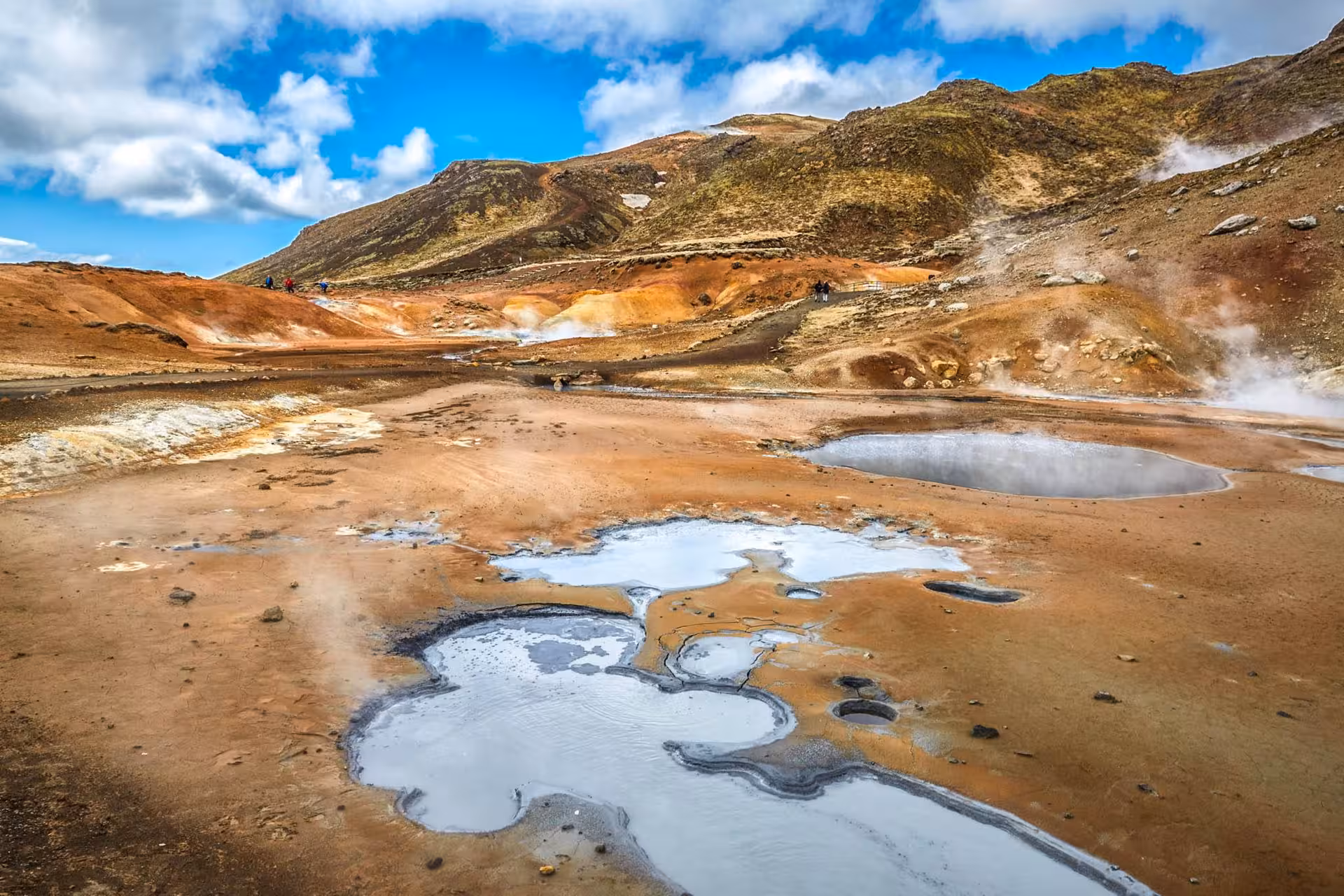 Steaming geothermal mud pools and colorful volcanic landscape on Reykjanes Peninsula, Iceland