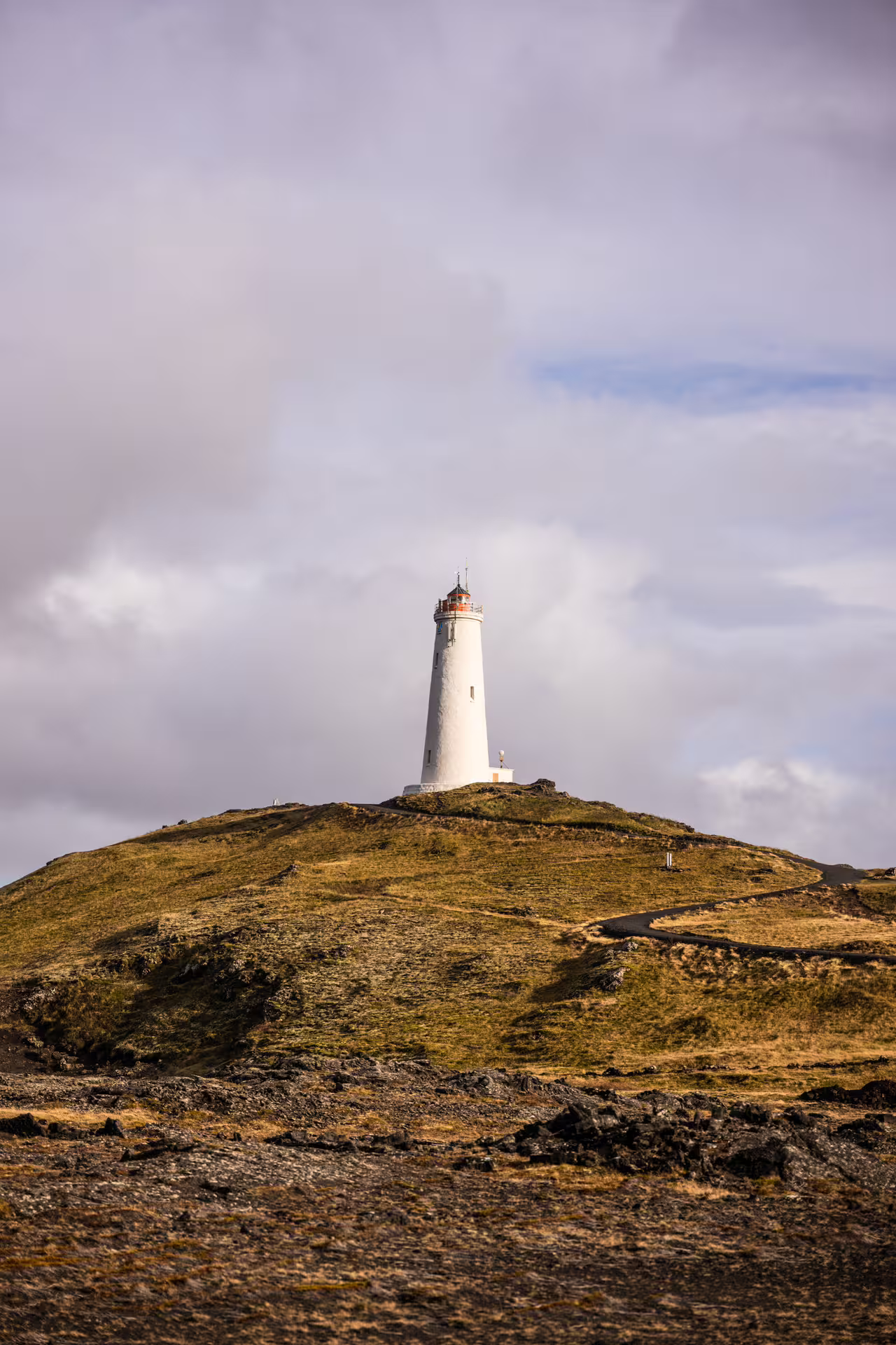 Iconic white Reykjanes lighthouse atop a volcanic hilltop captured on a professional Iceland photography day tour