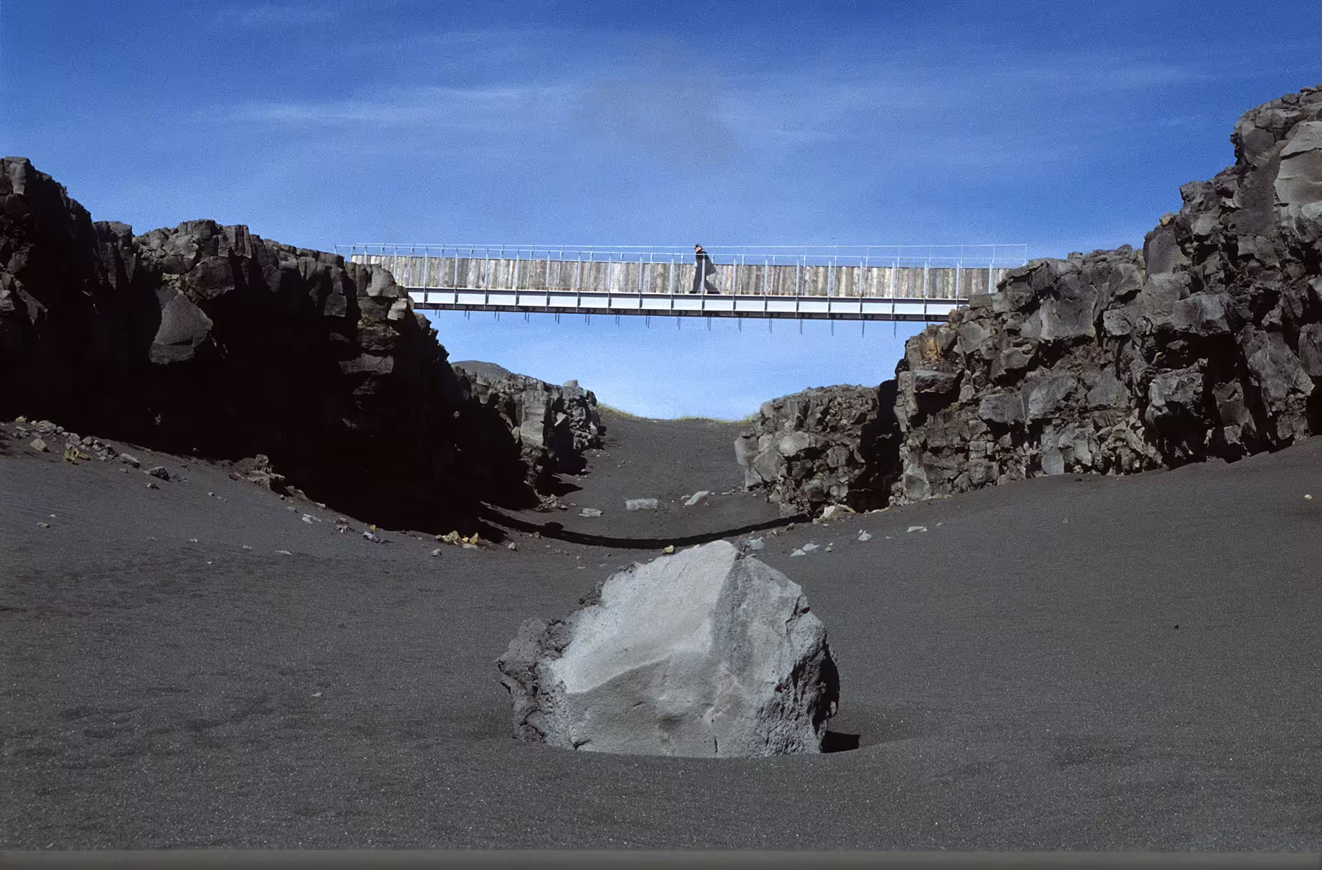 Bridge over black volcanic rift valley on Reykjanes Peninsula, Iceland