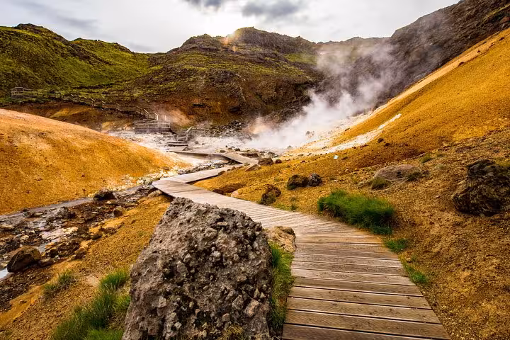Wooden boardwalk trail through steaming geothermal landscape on Reykjanes Peninsula, Iceland