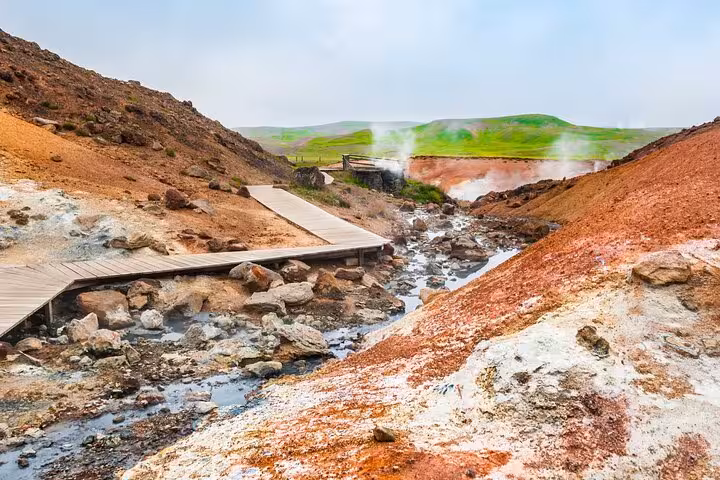 Geothermal hot springs with wooden boardwalk and colorful mineral deposits on Reykjanes Peninsula, Iceland