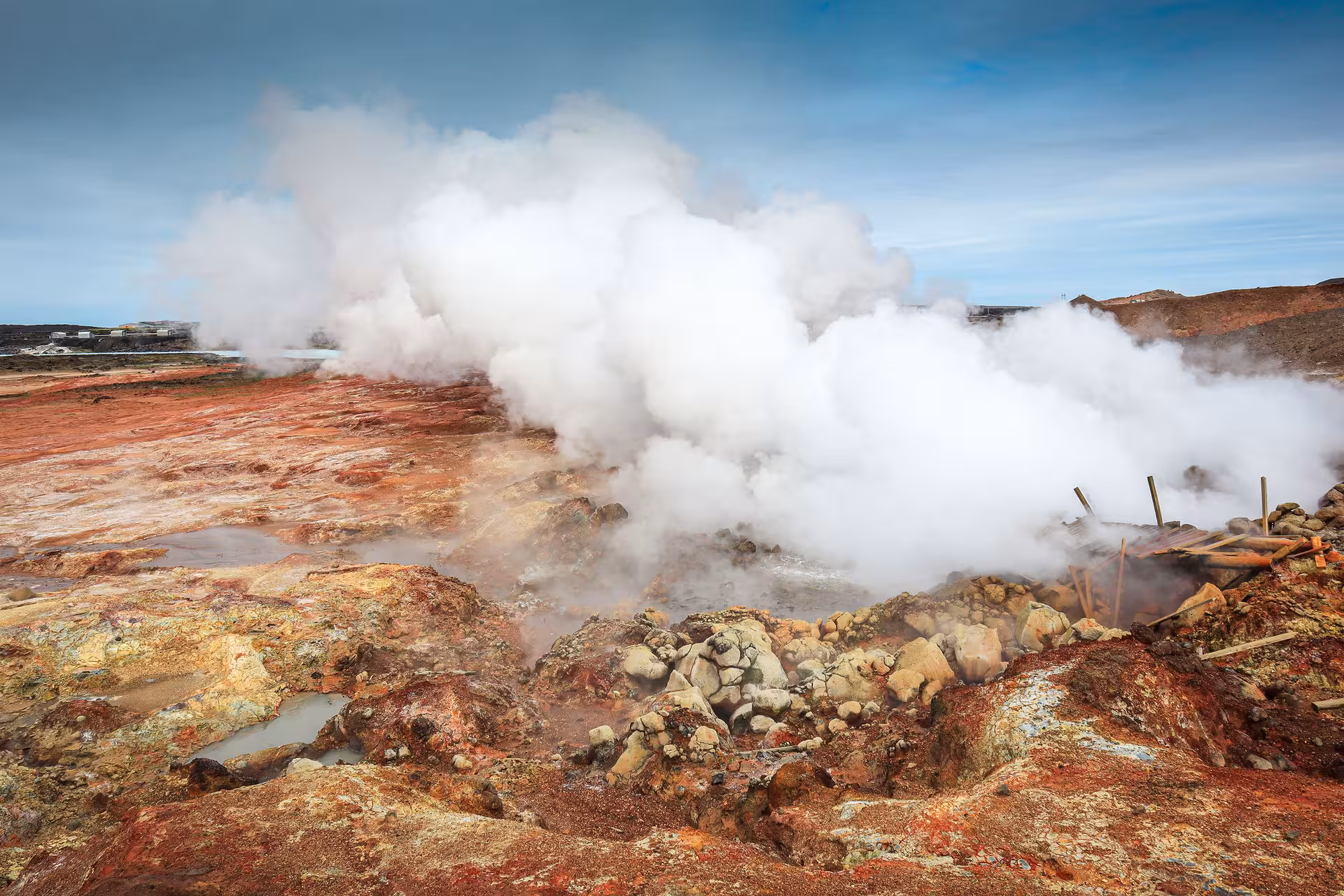 Steaming geothermal vents with colorful mineral-stained rocks on Reykjanes Peninsula, Iceland