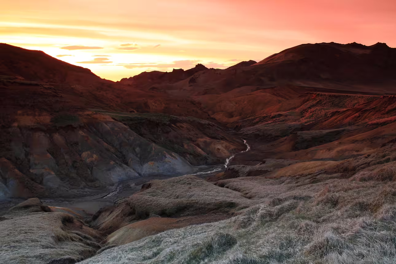 Dramatic sunset over volcanic valley with winding stream on Reykjanes Peninsula, Iceland