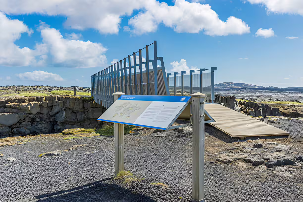 Informational sign and bridge at tectonic plate boundary on Reykjanes Peninsula, Iceland