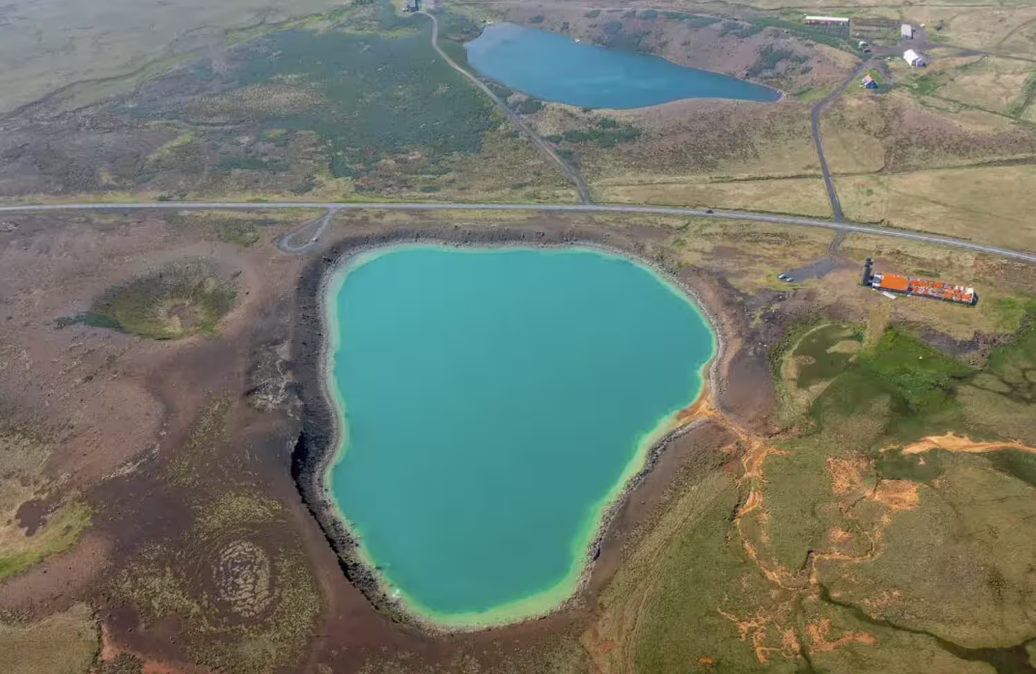 Aerial view of a turquoise volcanic crater lake on the Reykjanes Peninsula, Iceland