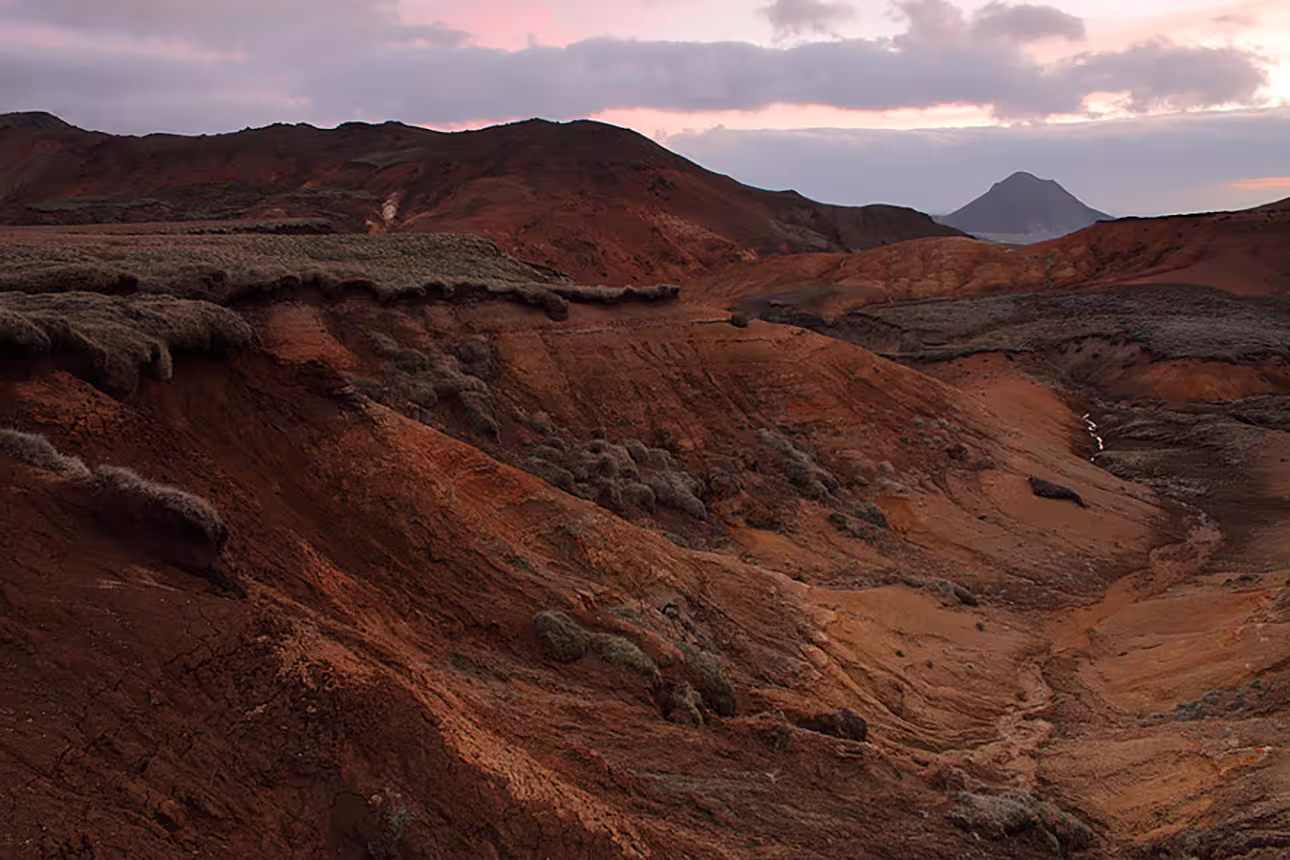 Red volcanic hills and eroded terrain at sunset on the Reykjanes Peninsula, Iceland