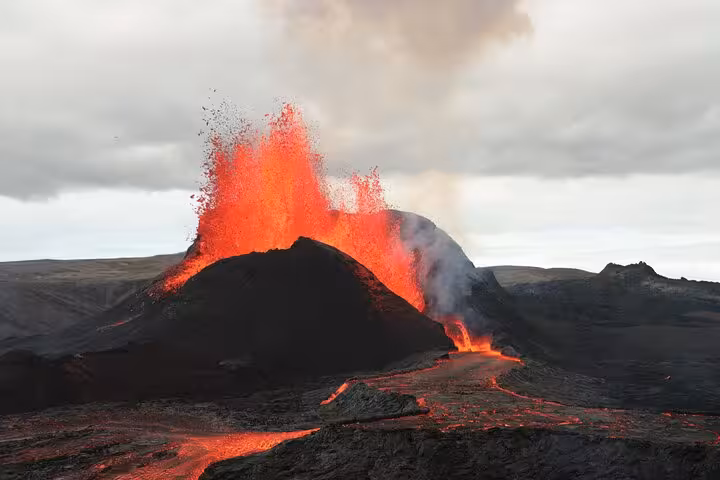 Active volcano erupting with bright red lava fountains and lava flows on Reykjanes Peninsula, Iceland