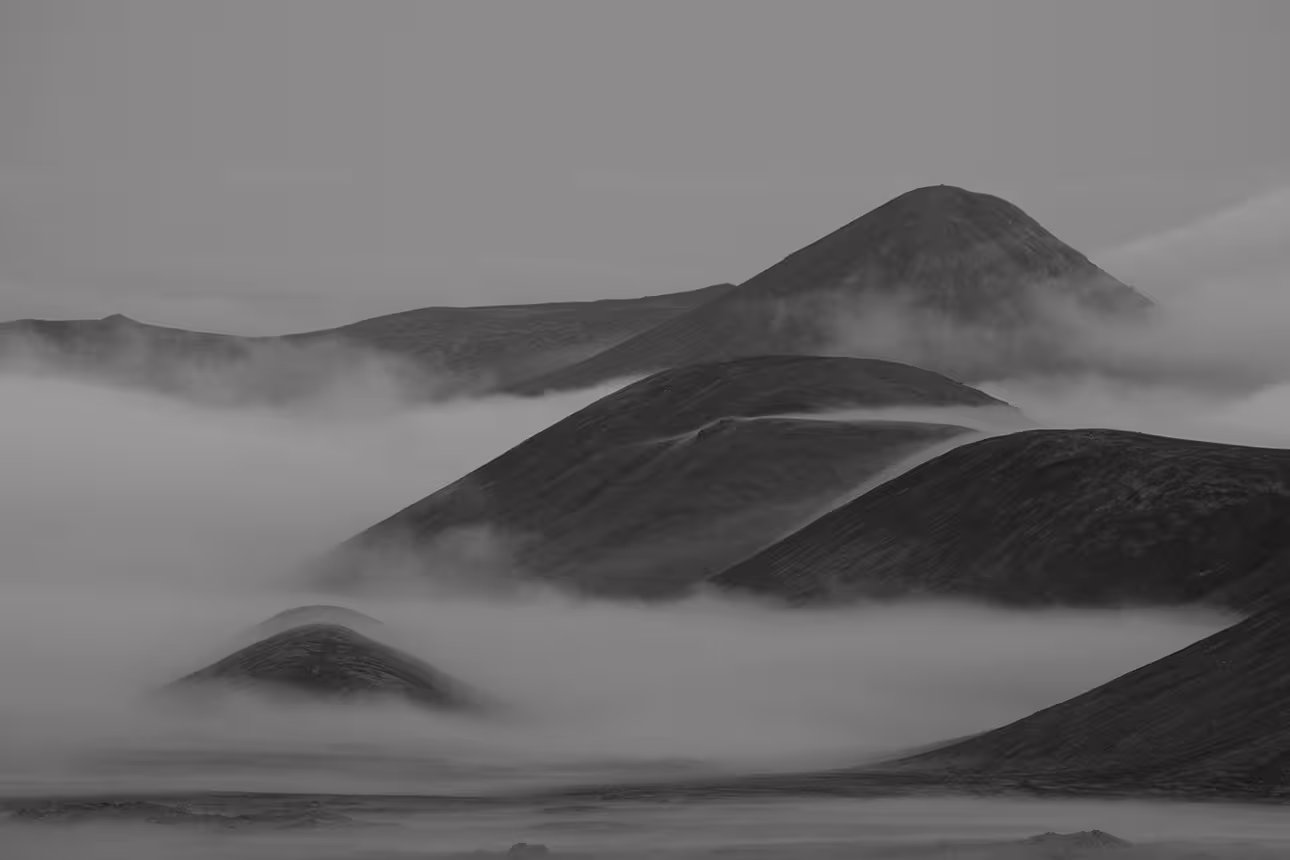 Volcanic hills emerging through thick fog on the Reykjanes Peninsula, Iceland, black and white
