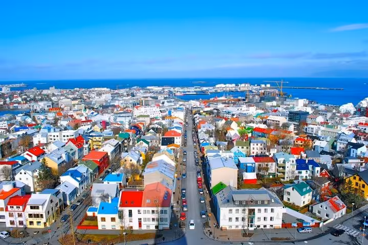 Aerial view of colorful rooftops in Reykjavik city center with ocean in background