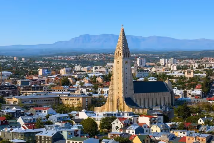 Aerial view of Reykjavik city with Hallgrímskirkja church tower and mountains in background