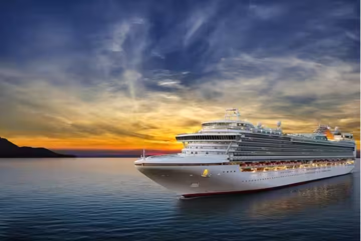 Large cruise ship sailing at sunset near Reykjavik cruise port on calm waters