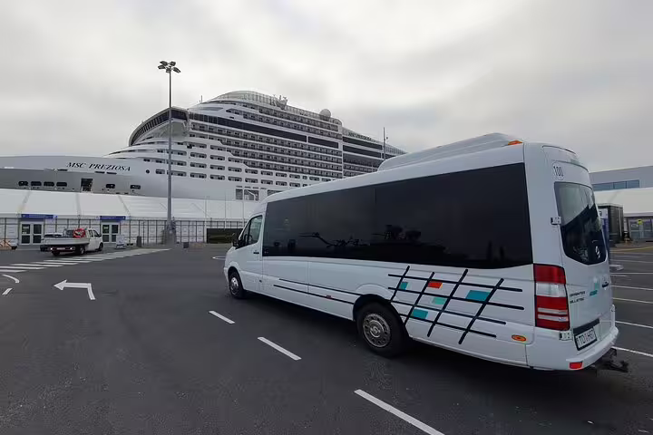 White minibus at Reykjavik cruise port with MSC Preziosa ship docked in background