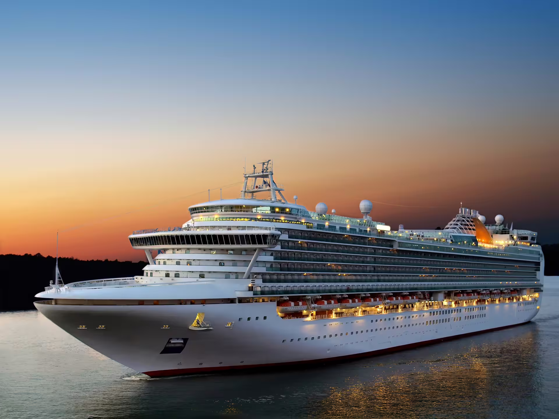 Large cruise ship illuminated at sunset sailing into Reykjavik cruise terminal