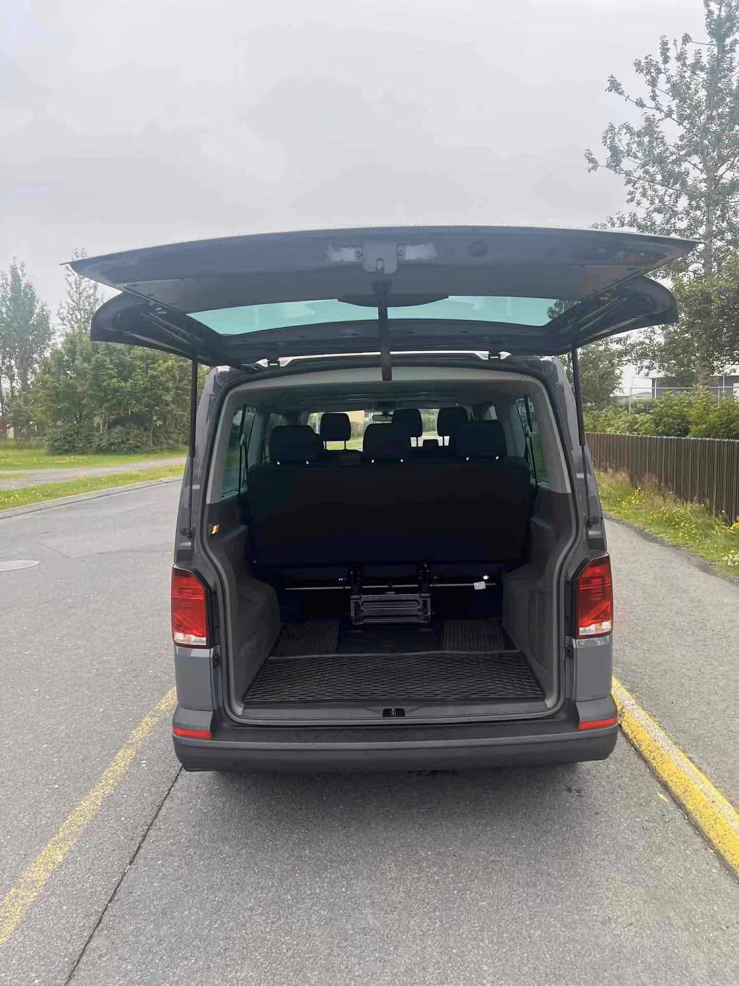Reykjavik Golden Circle tour minibus with open rear hatch, showing spacious luggage area for day trip