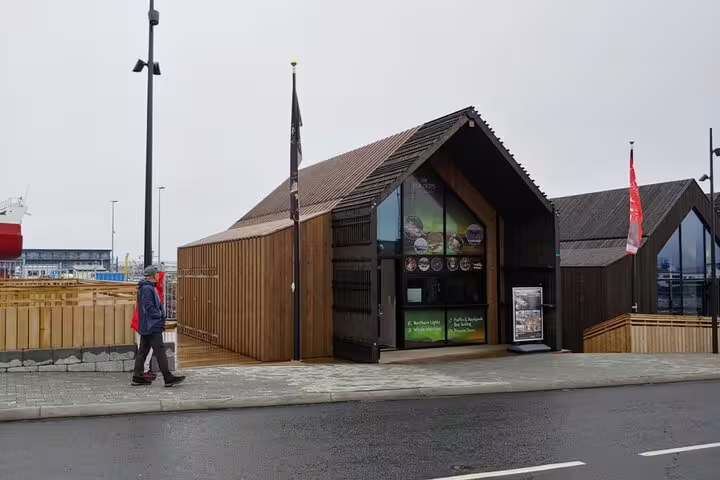 Wooden tour operator kiosk at Reykjavik harbor offering Northern Lights boat tours