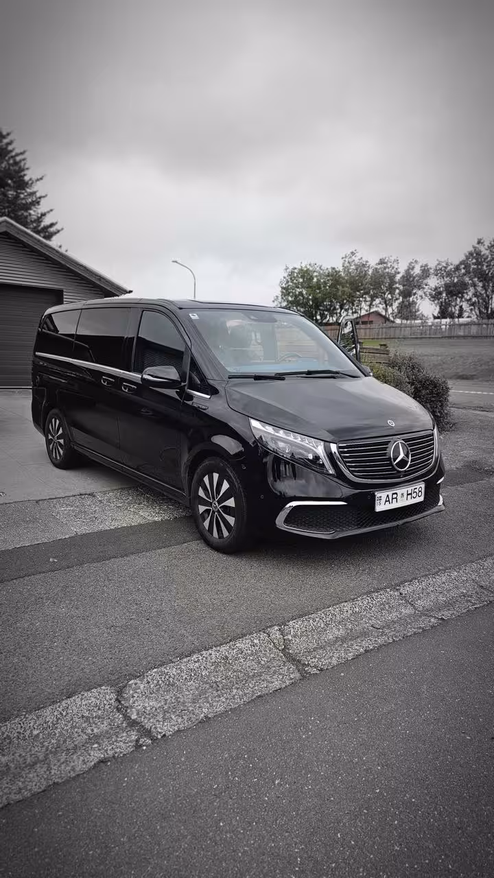 Black Mercedes-Benz EQV luxury MPV van parked in Reykjavik, Iceland, for private airport transfer